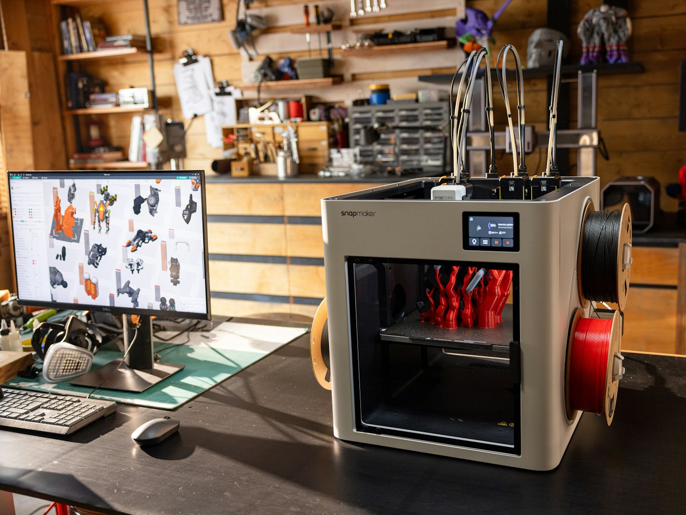 Snapmaker U1 3D printer printing a red part in a home workshop