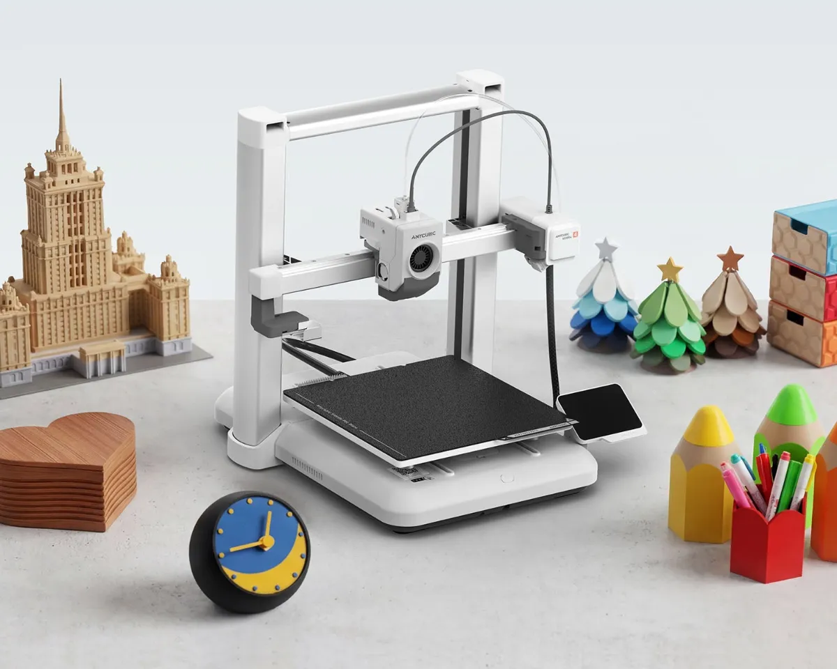 Anycubic Kobra 4 open-frame bed slinger 3D printer on a desk with multicolor printed models